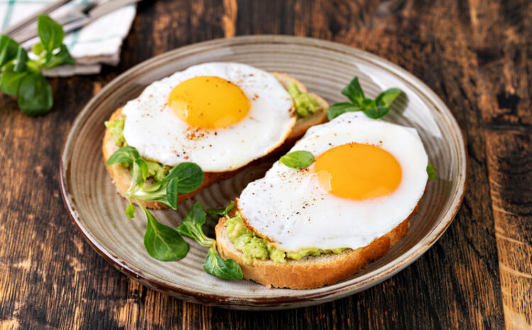 toast with fried egg on a wooden table